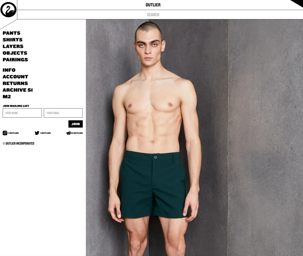 Product display on the Outlier website showing a male model wearing green shorts against a gray concrete background. The model is standing shirtless, and the left side of the webpage features a navigation menu with links to categories such as pants, shirts, layers, objects, and pairings, along with social media icons and a mailing list sign-up form.