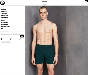 Product display on the Outlier website showing a male model wearing green shorts against a gray concrete background. The model is standing shirtless, and the left side of the webpage features a navigation menu with links to categories such as pants, shirts, layers, objects, and pairings, along with social media icons and a mailing list sign-up form.