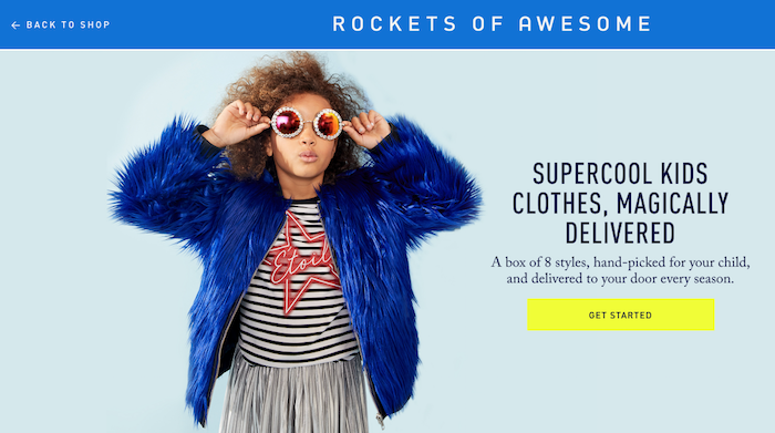Young girl, approximately age 7, wearing fuzzy blue coat, striped shirt, and bright yellow sunglasses from Rockets of Awesome