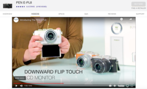 Still frame of woman showing flip screen feature on Olympus PEN L8 camera