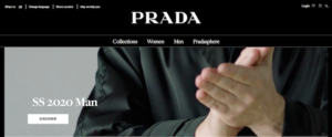 Prada landing page shows close up of man's hands clapping. Also shows clear navigation to product categories.